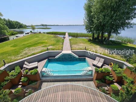 Infinity glazing for an outdoor pool