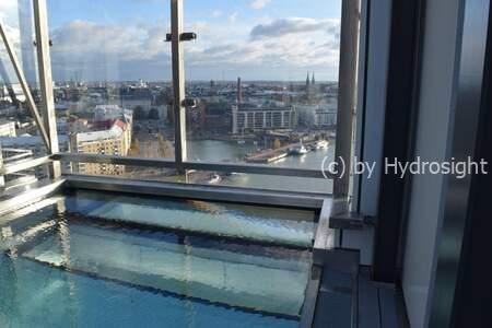 The system incorporates two distinct glazing components. The underwater section utilizes specialized glazing, traditionally made from high-strength acrylic, to provide a safe and clear view below the waterline. This Hydrosight underwater window is engineered with integrated fasteners designed to support the above-water glazing. For the above-water section, a glass balustrade system is employed. This balustrade is sourced from a certified railing specialist, ensuring structural integrity and compliance with safety standards. The Hydrosight system is designed for applications where there is a need for a safe transition between underwater viewing and an above-water barrier, such as in pool or aquarium settings.